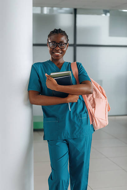 smart woman student with pink backpack is indoors.